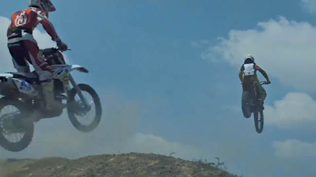 2 men racing in their motorcycles