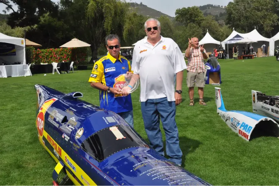 TOP 1 Ack Attack streamliner motorcycle and Rocky Robinson on a desert salt flat aiming for a 400 mph land speed record.