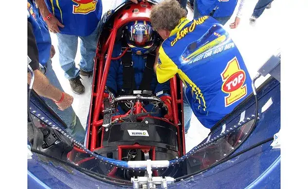 TOP 1 Ack Attack streamliner motorcycle and Rocky Robinson on a desert salt flat aiming for a 400 mph land speed record.