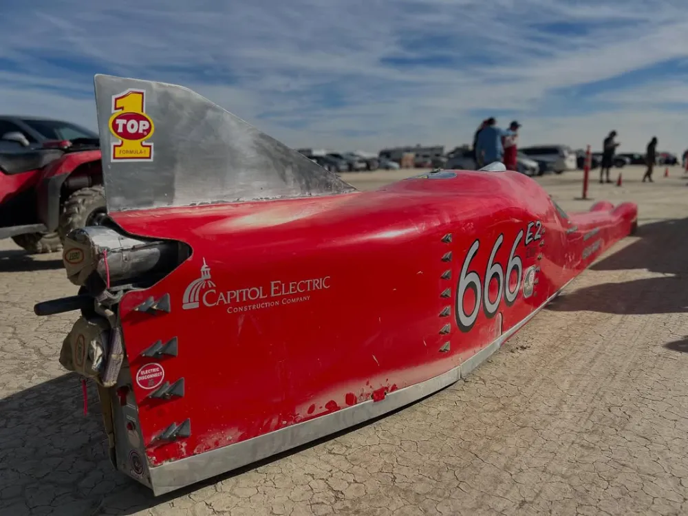 Jim Hoogerhyde prepares for a land speed records run in his Nebulous Theorem II EV streamliner at the El Mirage dry lakebed.