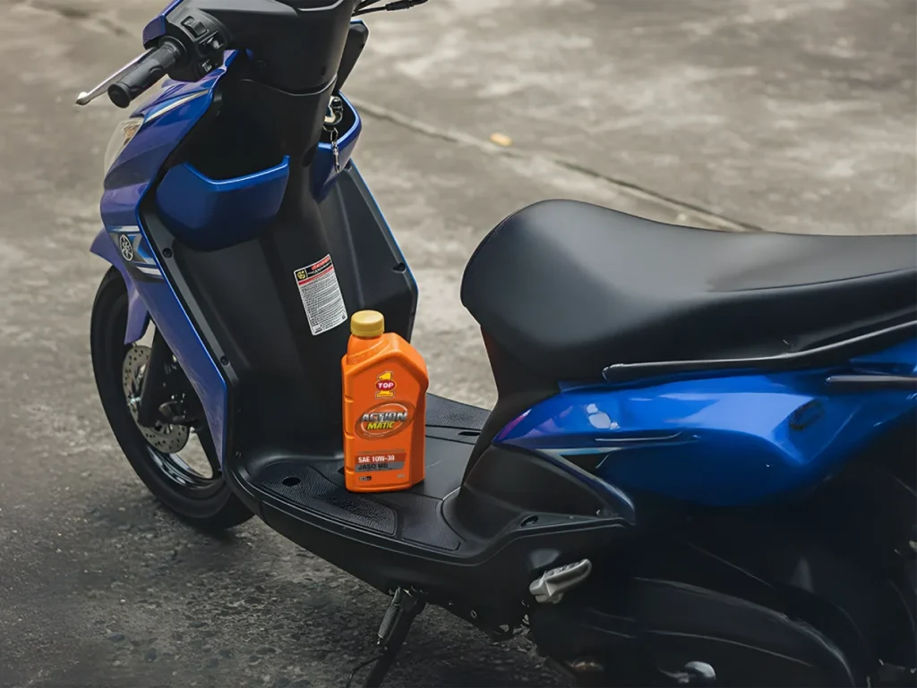 4-stroke engine oil action matic product on a blue scooter