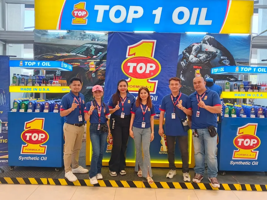 Philippine distributor team posing at the TOP 1 Oil booth at a trade show